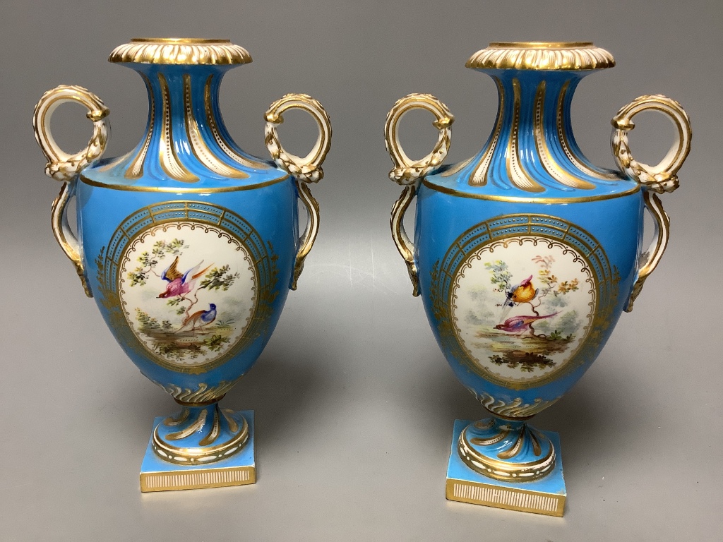 A pair of mid 19th century Coalport turquoise ground two handled vases, painted in Sévres style with birds in gilt panels 20.5cm